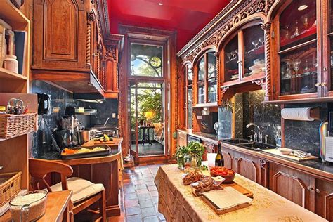 A Kitchen Opens Onto A Glass Enclosed Solarium At The Rear Of The