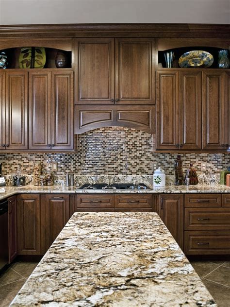 The subtle gray veining of the backsplash tile does not clash or compete with the granite's dramatic patterning, but rather enhances the white veining. Backsplash for granite counters