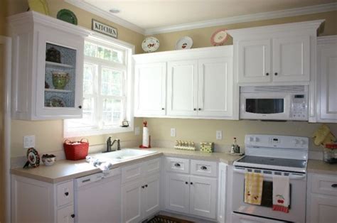 With white as the base color, it's easy to update and freshen up your kitchen with splashes of color. White Kitchen Cupboards With White Appliances - Small House Interior Design