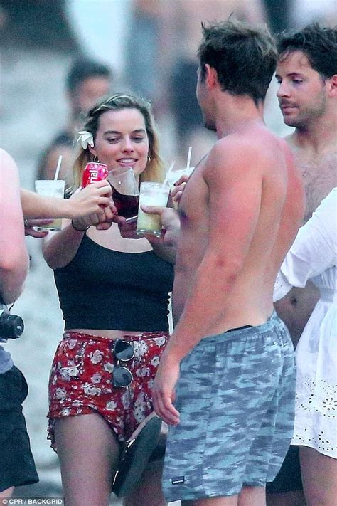 Margot Robbie Tenderly Kisses Husband Tom Ackerley S Shoulder Daily Mail Online