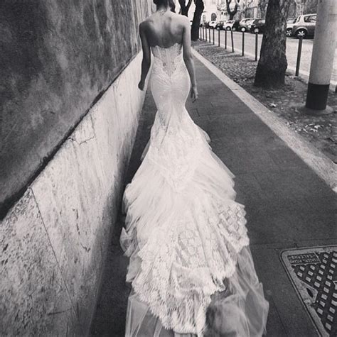 Delicate flowers are tastefully strewn across the. Tight figure hugging lace wedding dress back | Wedding ...