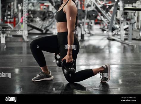 Female Athlete Doing Lunges With Kettlebells Stock Photo Alamy