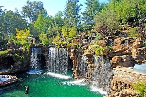 A Luxurious Pool With A Waterfall And A Cave At Old Lion