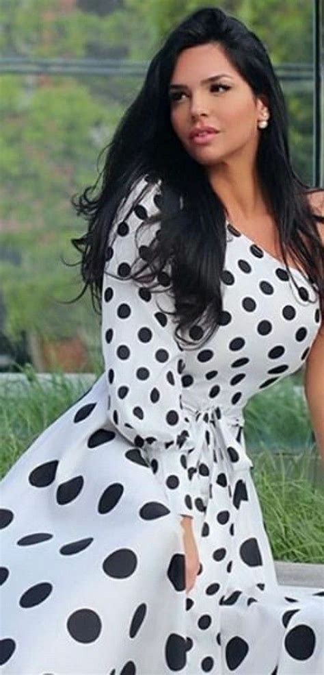 A Woman In A Polka Dot Dress Posing For The Camera