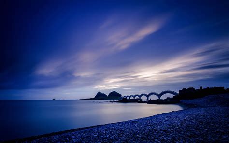 Download Wallpaper 3840x2400 Sea Coast Stones Bridge Sunset