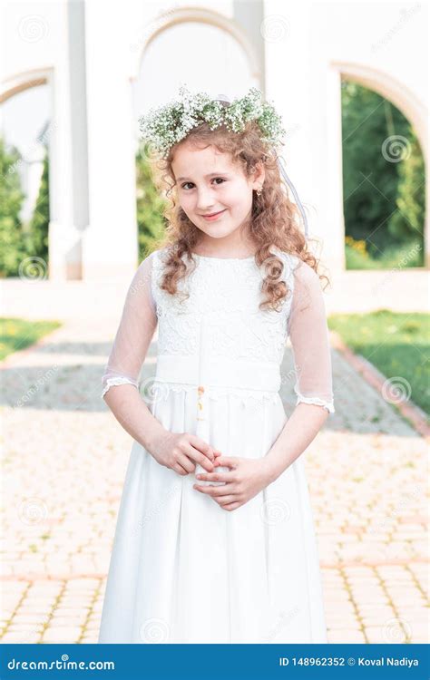First Communion Girl Portrait Of Cute Little Girl On White Dress And