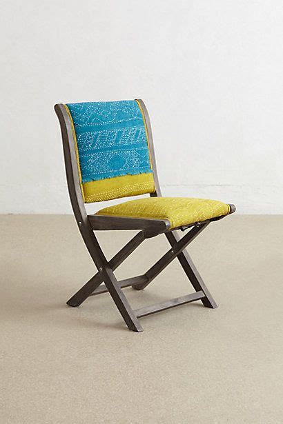 A Blue And Yellow Chair Sitting On Top Of A Floor Next To A White Wall