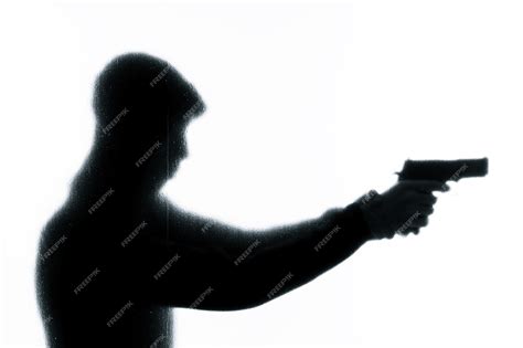 Premium Photo Silhouette Of A Man Holding A Gun