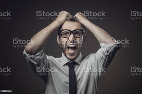 Angry Stressed Businessman With Head In Hands Stock Photo Download