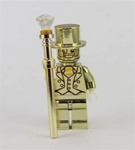 A Gold Lego Figure With A Top Hat Holding A Crystal Ball And A Stick In