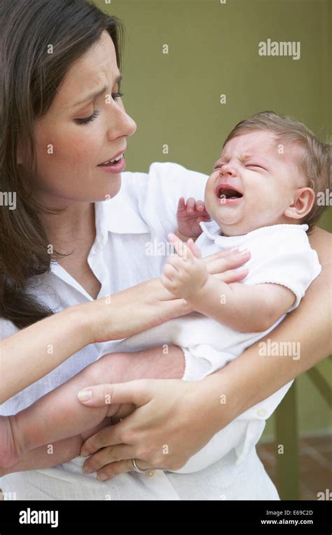 Mother Comforting Crying Baby Stock Photo Alamy
