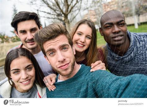 Multiracial Group Of Friends Taking Selfie In A Urban Park A Royalty