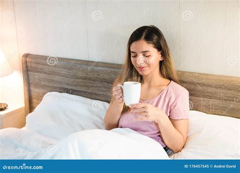 Morning Relaxation Young Relaxed Woman In Her Bed Enjoying A Cup Of
