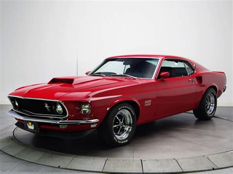 A Red Muscle Car Sitting On Top Of A Cement Floor