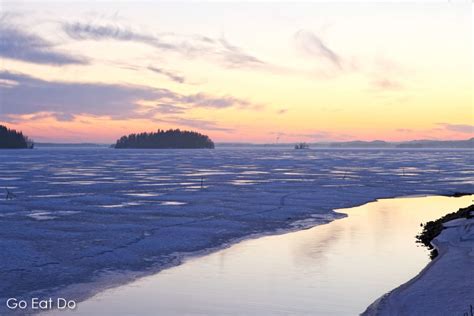 Winter Sunset Over The Mainly Frozen Surface Of Lake Pyhajarvi On The
