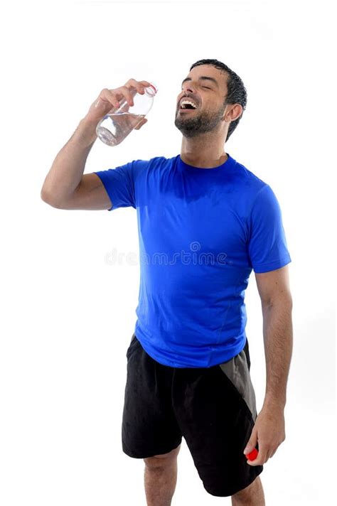 Young Attractive And Athletic Sport Man Drinking Water Stock Photo