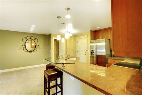 Bright Kitchen Room Interior With Granite Counter Top And Breakfast Bar