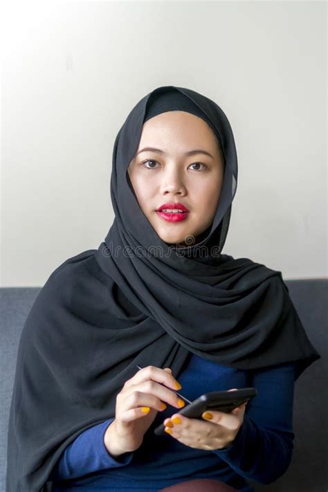 Asian Malay Girl Wearing Hijab Sitting In The Sofa Stock Image Image