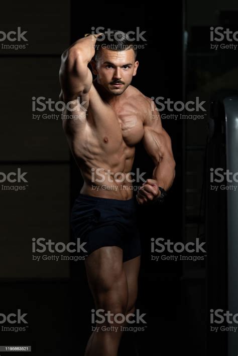 Young Bodybuilder Flexing Muscles Stock Photo Download Image Now