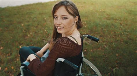 Beautiful Disabled Bride Posing In A Wheelchair Against The Background