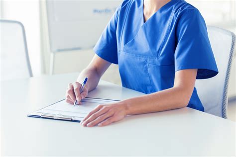 Close Up Of Doctor Or Nurse Writing To Clipboard Rotunda