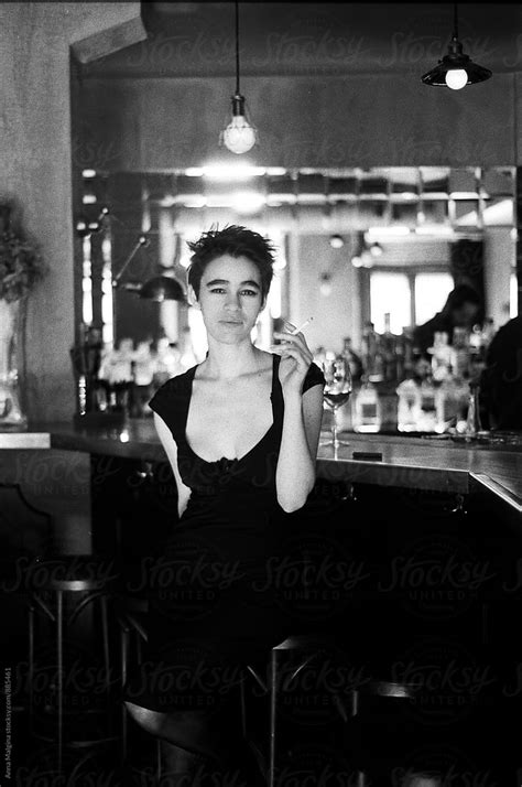 Young Woman Smoking Cigarette In Bar By Stocksy Contributor Anna