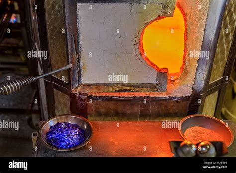 Glass Blowing Furnace And Table With With Crushed Glass And Tools At A Glass Maker S Workshop