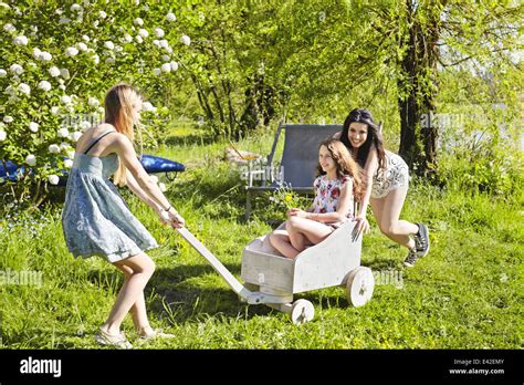 Young Women Playing With Toy Cart Stock Photo Alamy