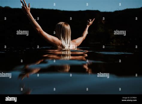 Beautiful Woman Skinny Dipping And Wild Swimming In River Stock Photo