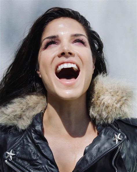 A Woman With Her Mouth Open And Wearing A Leather Jacket