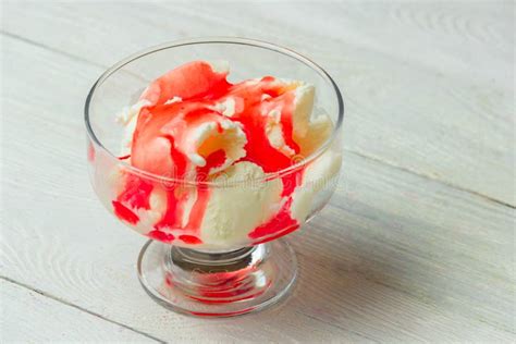 Delicious Bowl Of Vanila Ice Cream With Strawberry Topping Stock Image