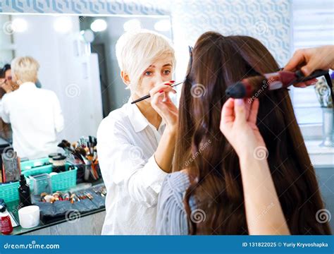 Beauty Salon Specialists Doing Professional Makeup And Hairstyle For