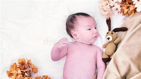 A Newborn Baby Is Lying On A White Fur In A Cap Stock Photo Image Of