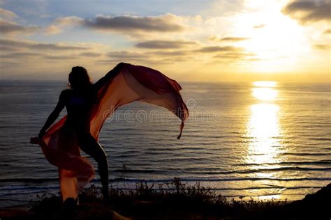 Lovely Brunette Bikini Model Relaxing On The Shoreline At Sunset Stock