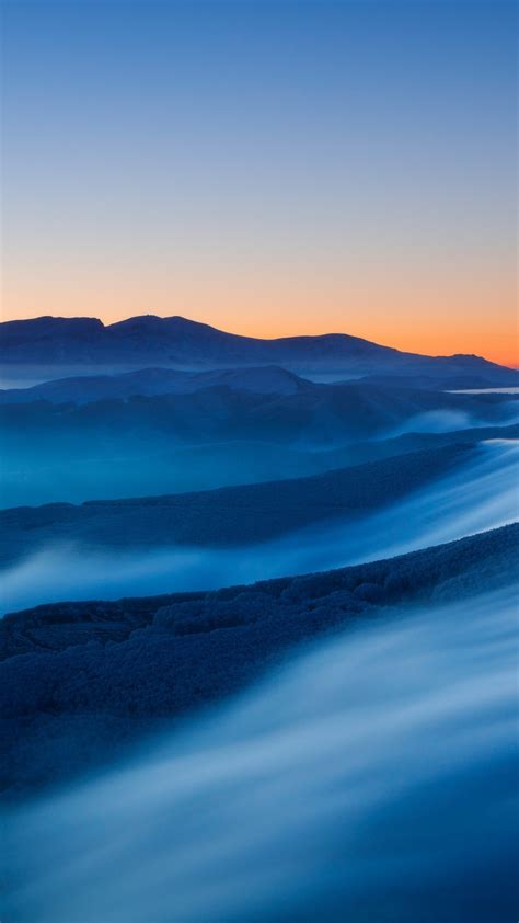 Download Wallpaper 720x1280 Sunset Mountains Fog Horizon Landscape