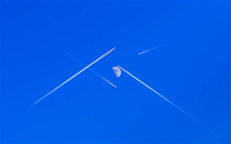 Planes Fly Crossing Their Paths To Each Other Directly Under The Moon
