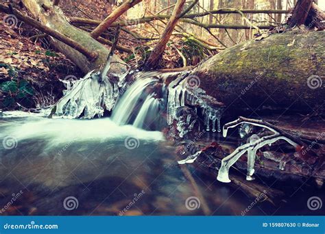 Frozen Cascade Of Waterfall Icy Twigs And Boulders In Frozen Foam Stock