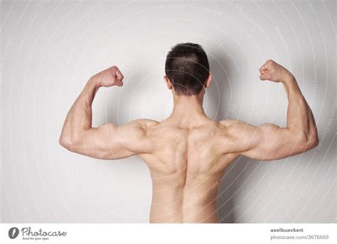 Man Flexing Biceps And Back Muscles A Royalty Free Stock Photo From