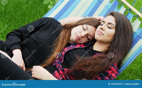 Two Girlfriends Hug And Sleeping In Hammock In Garden Lesbian Couple Lgbt Concept Stock Video