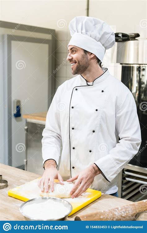 Cook In Chefs Uniform Smiling And Kneading Dough On Stock Image Image