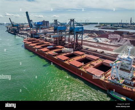 Bulk Carrier Ship Unloading Cargo By Crane At Port Stock Photo Alamy