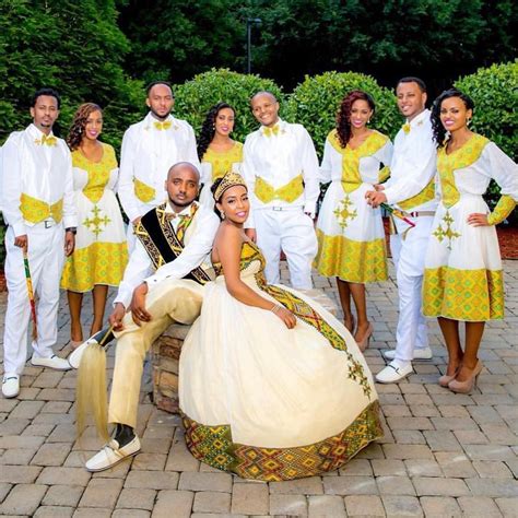A Group Of People In White And Yellow Outfits Posing For A Photo On A