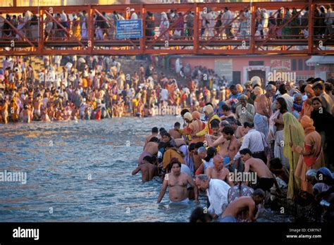 hindu pilgrims taking a holy bath in the ganges river during the kumbh or kumbha mela har ki