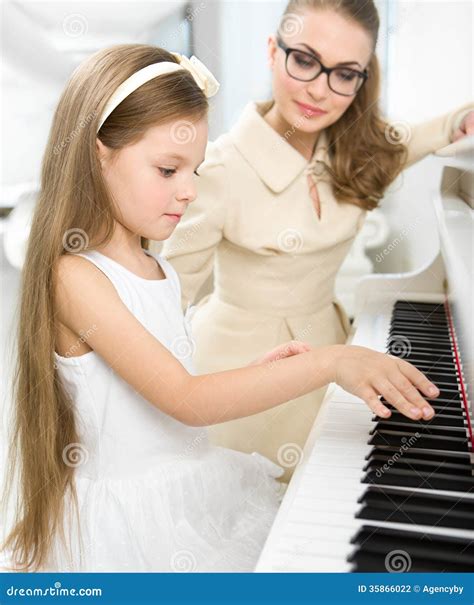 Tutor Teaches Little Pianist To Play Piano Stock Photo Image Of Home