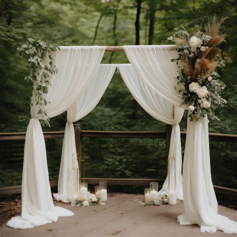Premium Ai Image A Wedding Arch With White Drapes And Greenery And