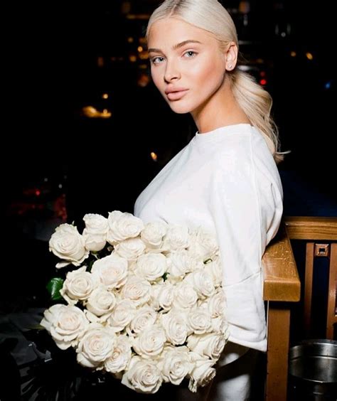 A Woman Holding A Bouquet Of White Roses