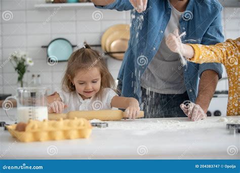 Smiling Father And Daughters Baking In The Kitchen And Having Fun Stock Image Image Of