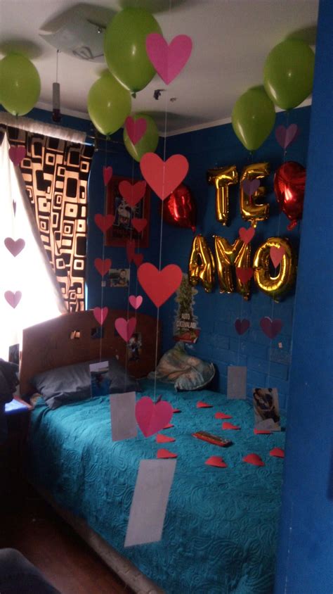 A Bedroom Decorated For Valentines Day With Balloons And Streamers