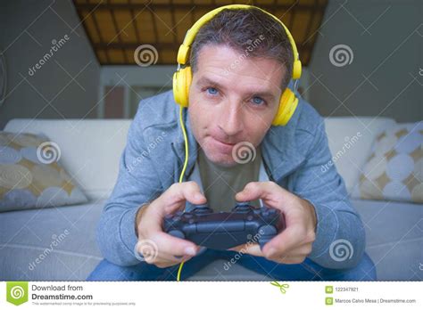 Lifestyle Portrait Of Young Happy And Excited Gamer Man With Headphones