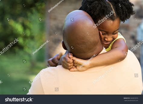 African American Father Hugging His Daughter Stock Photo 304301819